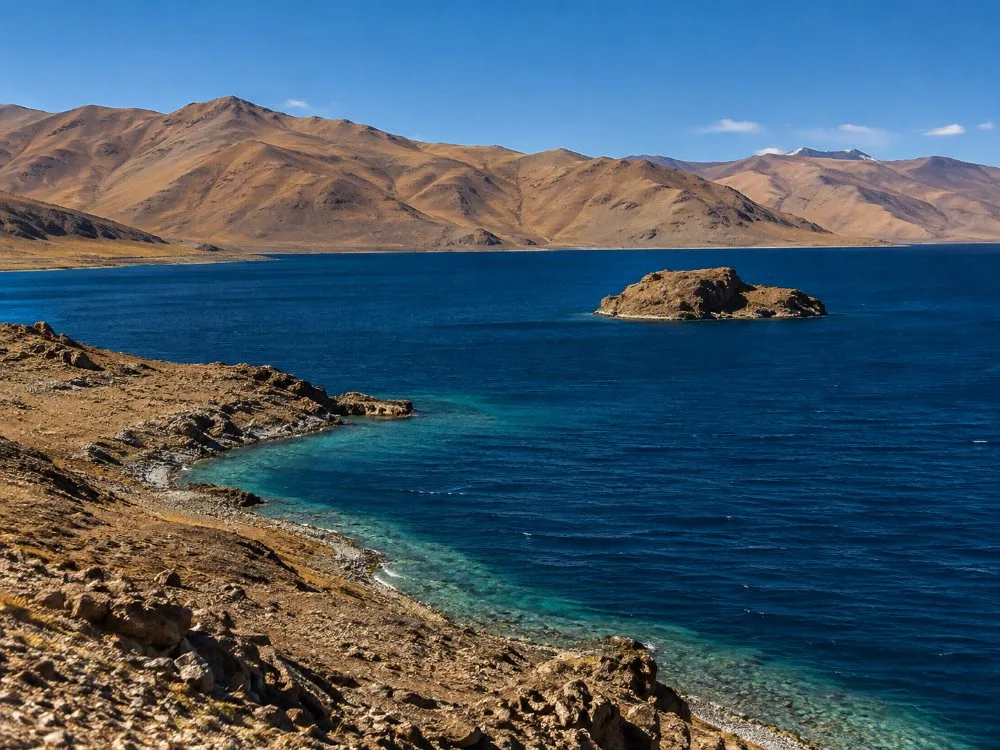 Rakshastal, deep blue under bare brown hills